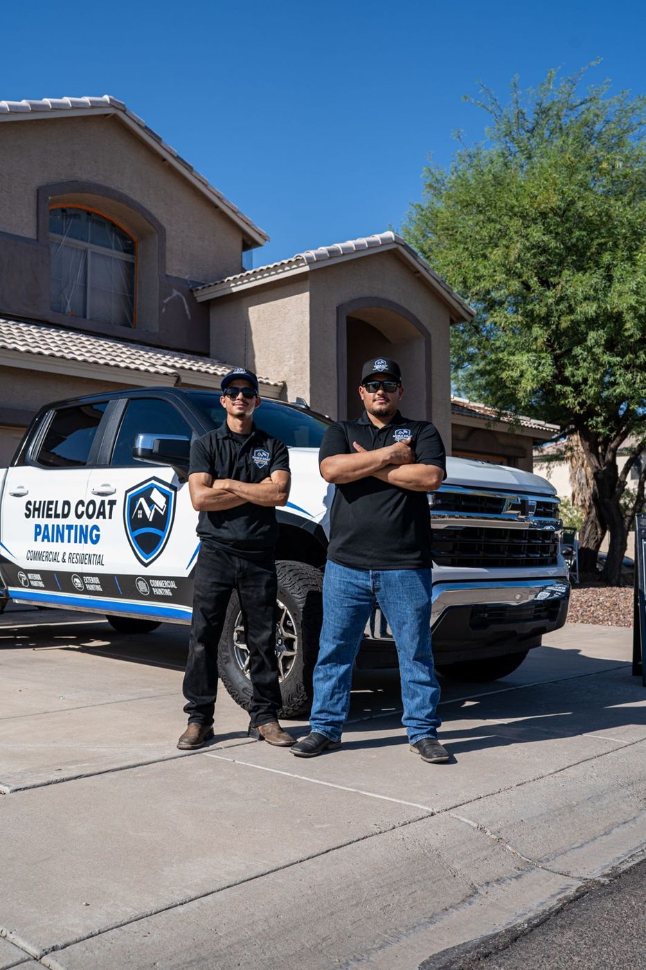 Shield Coat Painting owners Aedan and Brayan Rivas with their company truck in Phoenix